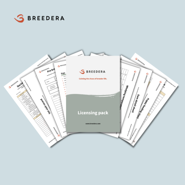 Image displaying a brochure for BreederA titled 'Licensing Pack.' The cover of the brochure features the BreederA logo and the slogan 'Calming the chaos of breeder life.' Behind the cover, various informational sheets are partially visible, including a 'Socialization checklist,' 'Pre-breeding checklist,' 'Vet visit record,' and 'Whelping temperature log.' The pages are laid out on a light blue background.