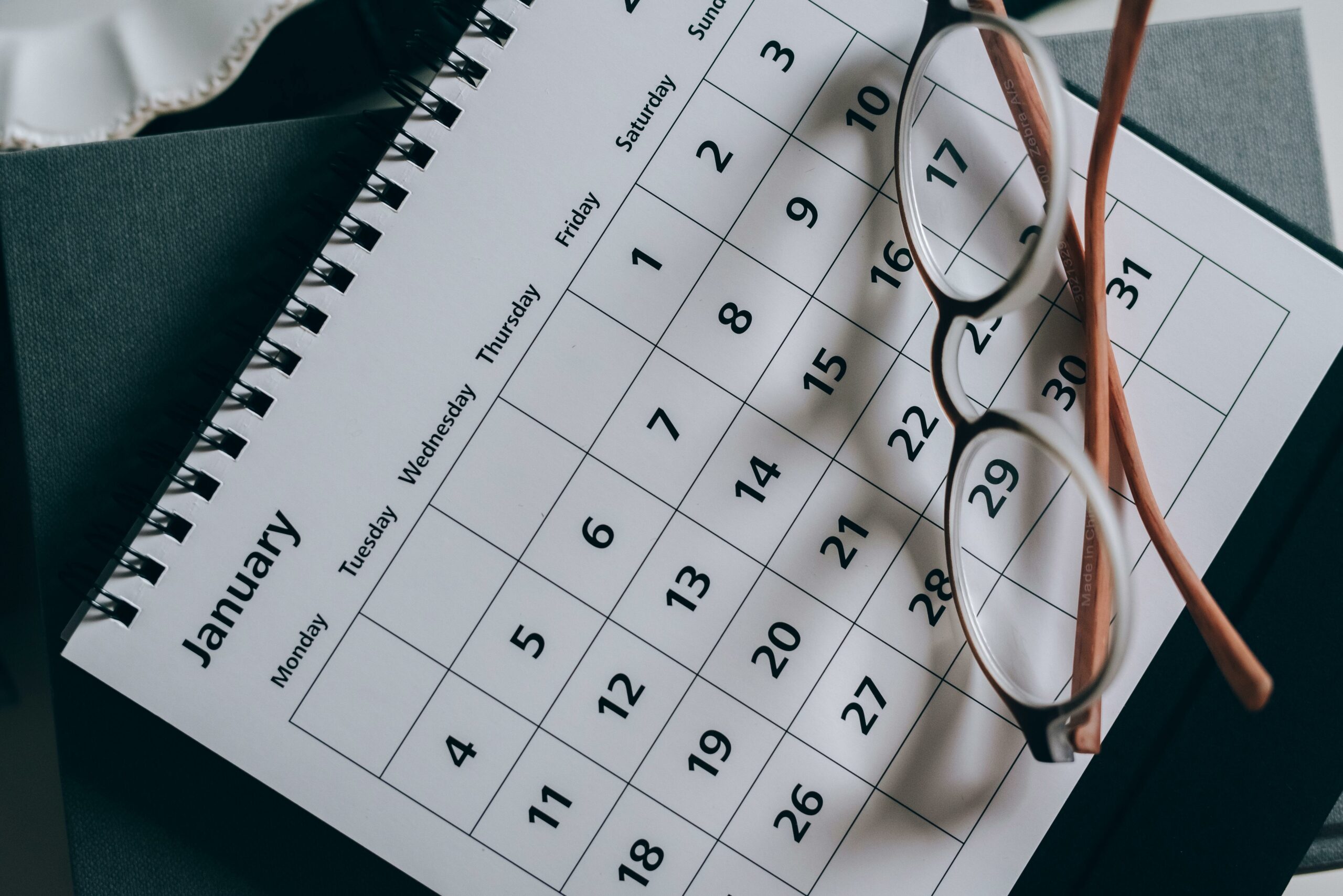 A-dog-breeders-calendar-with-a-pair-of-glasses-on-top